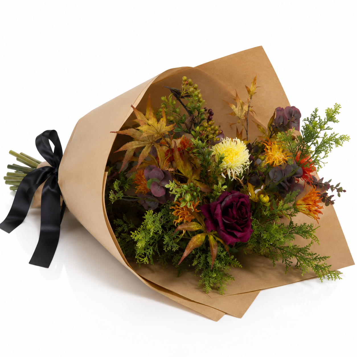 Artificial chrysanthemum and autumn foliage bouquet in rich orange, burgundy and green tones, wrapped in brown kraft paper with a black satin ribbon.