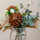 Close up of artificial chrysanthemum, rose and astilbe bouquet in warm autumn tones, displayed in a clear glass rope vase available separately.