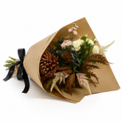 Artificial chrysanthemum, rose and astilbe bouquet in warm autumn tones, wrapped in brown kraft paper with a black satin ribbon.