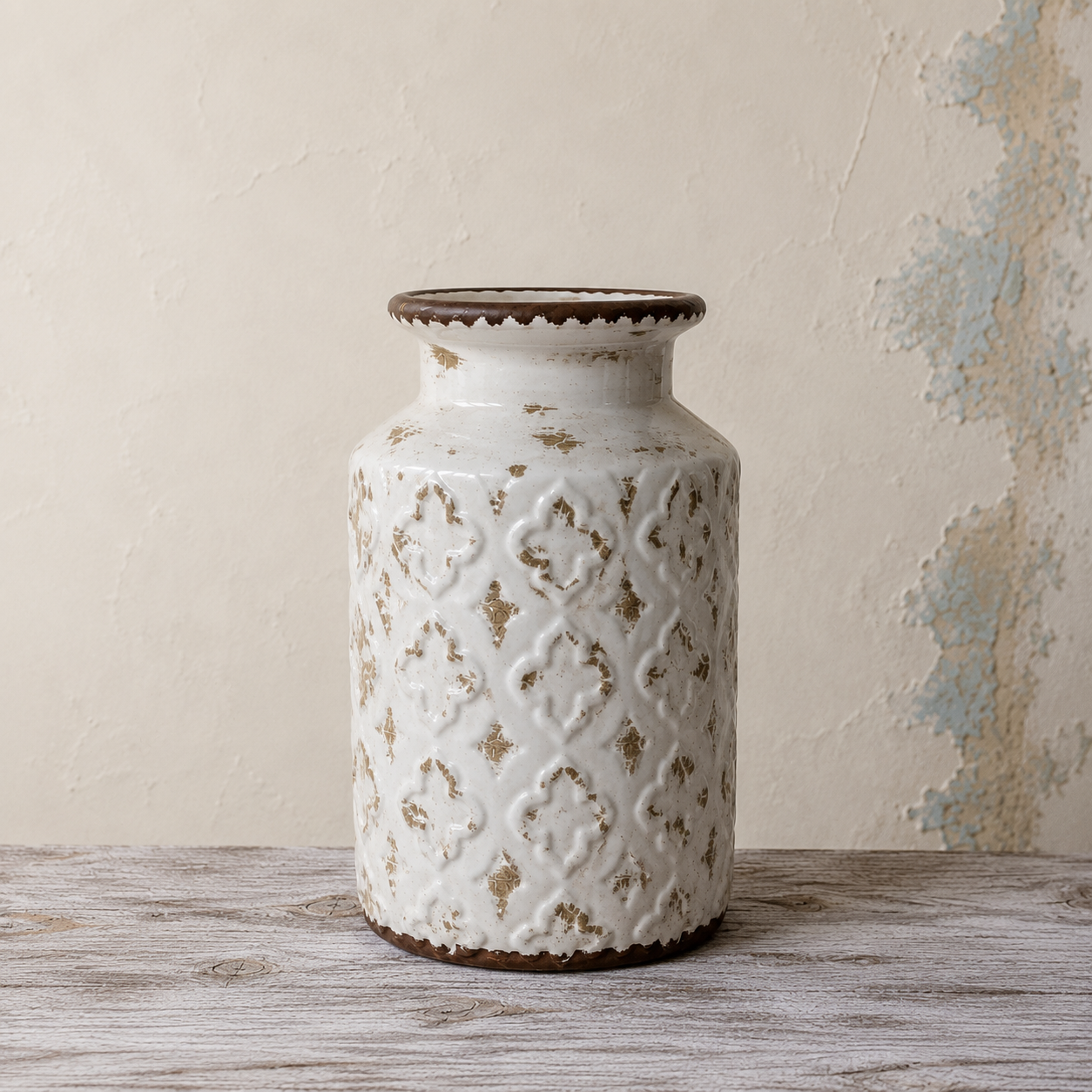 Rustic embossed ceramic vase with an ivory distressed finish and decorative geometric pattern