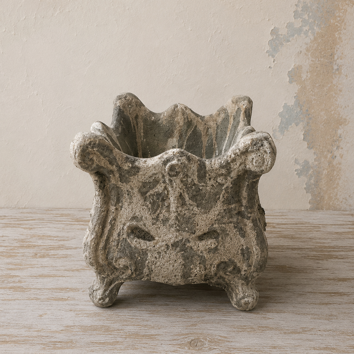 Scalloped square planter with an ornate design and distressed stone-effect finish.