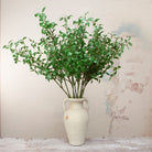 Artificial privet stems displayed in ceramic vase for styling purposes only