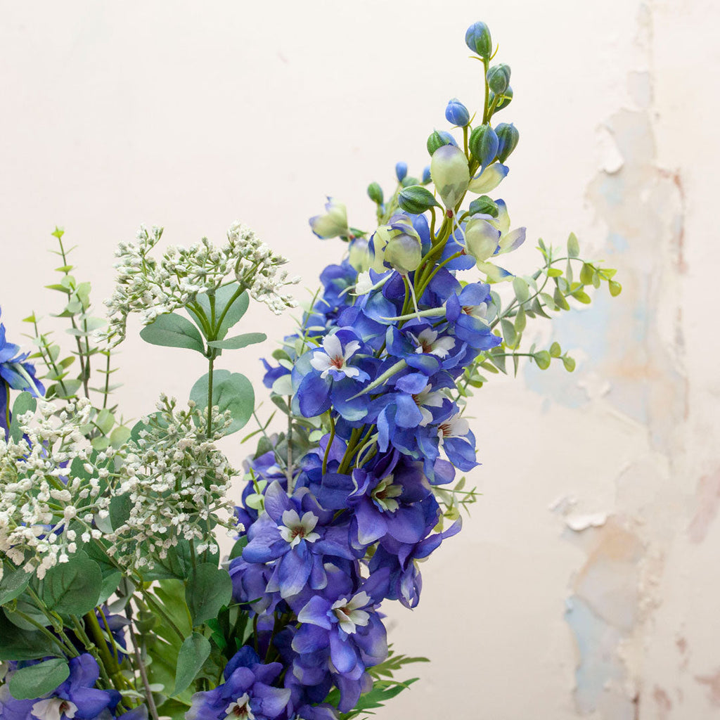 Delphiniums, achillea, eucalyptus & foliage in the Christina vase Peony