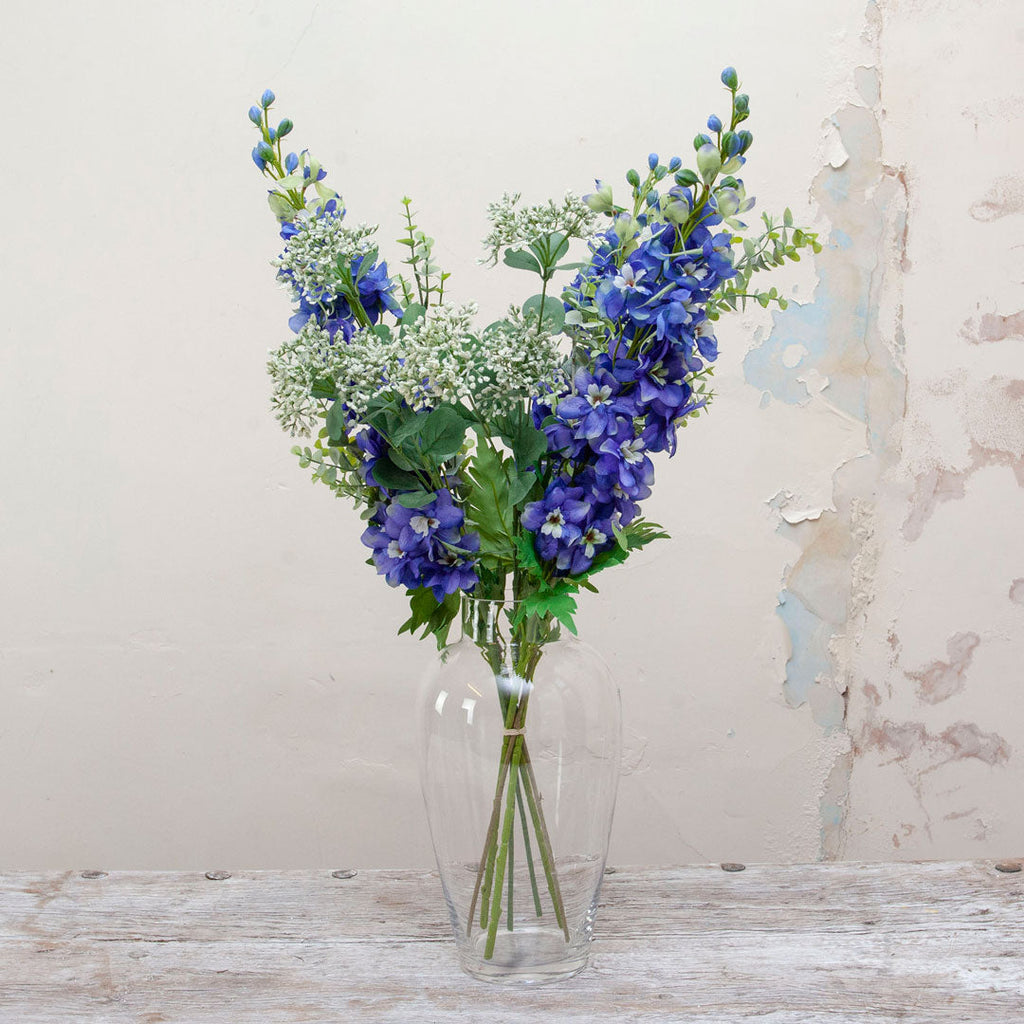 Delphiniums, achillea, eucalyptus & foliage in the Christina vase Peony