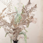 Close up view of Artificial Winter Foliage and Champagne Ferns in a Tall Black Vase, Set of Two