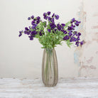 Artificial sweet pea stem displayed in a vase, showcasing elegant trailing stems with deep purple flowers for a dramatic yet romantic look
