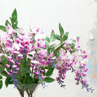 Long stem of romantic lavender wisteria with leaves. Peony