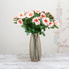 Pastel pink roses on a long stem with rose leaves. Peony