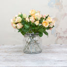 Faux peach rose stem with buds and leaves.