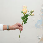 Peach with a touch of pink roses with buds and leaves.