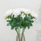 Close-up of artificial white rose flower, highlighting soft white petals with gentle tonal variation, detailed veining and realistic leaf texture