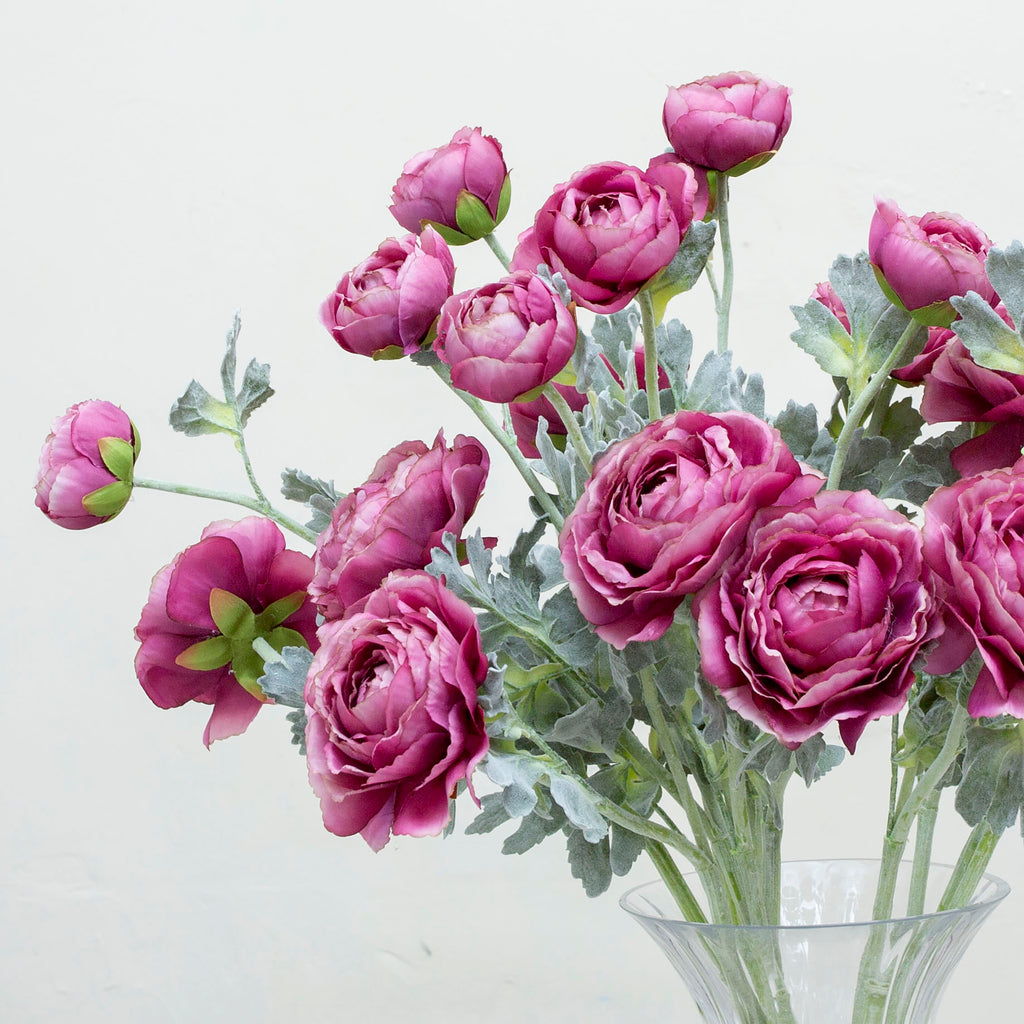 A lavender purple artificial ranunculus flower