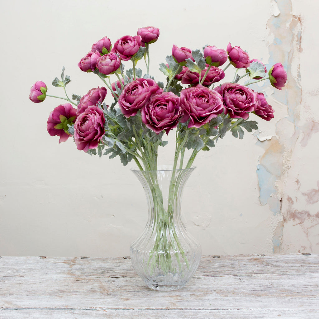 A lavender purple artificial ranunculus flower