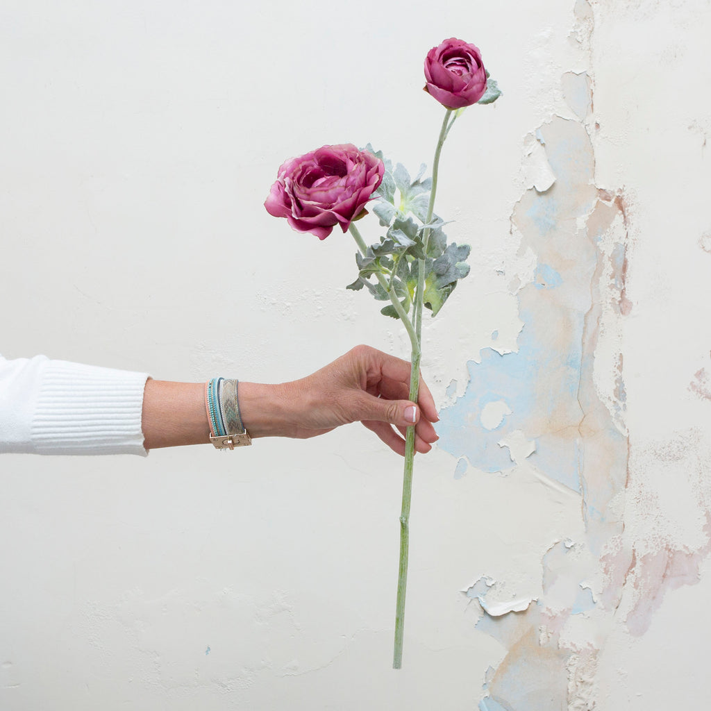 A lavender purple artificial ranunculus flower