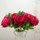 Dark fuchsia pink peony with leaves Peony